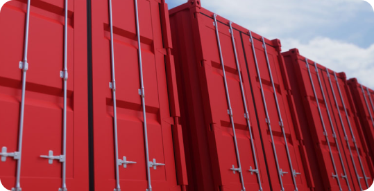 Three red shipping containers at a port