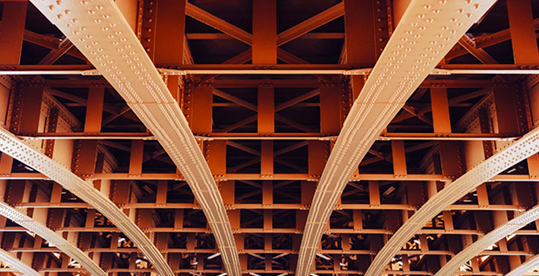 Structural beams under a bridge coated with protective coatings